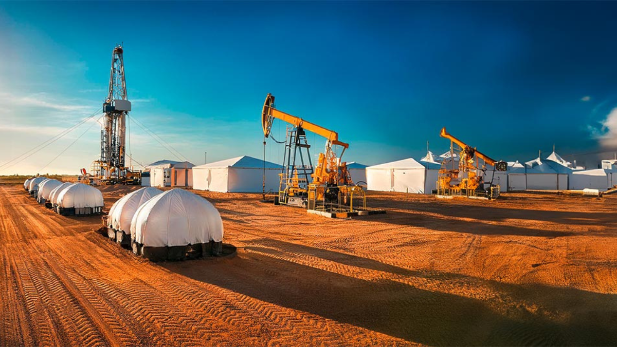 Middle East oilfield with pump jacks, drilling rig, and water infrastructure in desert.