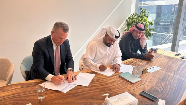 Business leaders signing partnership agreement for atmospheric water technology